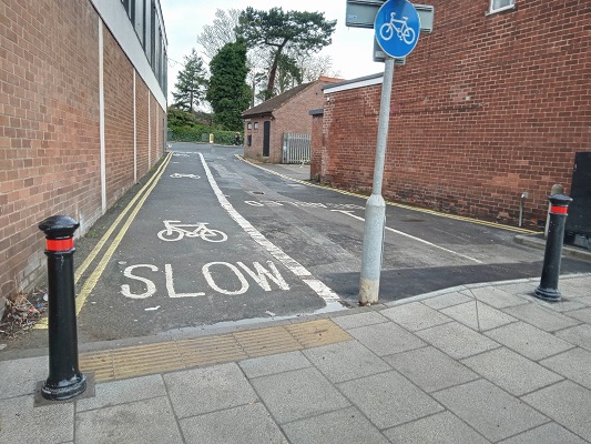 A cycle path on Cross Street, with bollards on either side to allow safe passage of cyclists but not cars