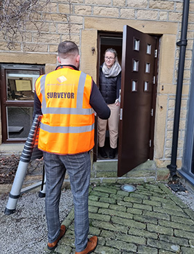 Housing condition survey - surveyor at exterior door