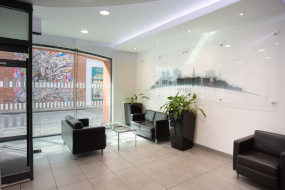 Photo of the inside of the reception of 18 Back Swinegate, including sofas, plants, and a coffee table