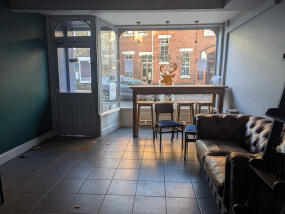 interior photo of 74 Gillygate showing the front area of the retail space, showing the front door and window overlooking the street