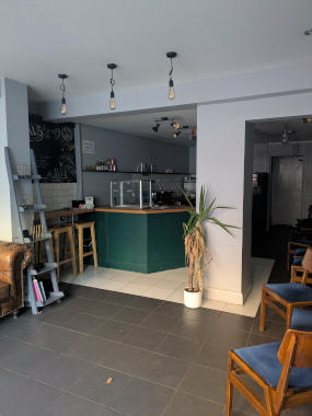 interior photo of 74 Gillygate of rear of the retail space, currently set out as a cafe food counter, with a pillar in the middle of the area
