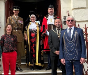 An image of a group of people including the Rt Hon Lord Mayor of York, Cllr Margaret Wells, Cllr Claire Douglas and members of the Armed Forces on the steps of the Mansion House