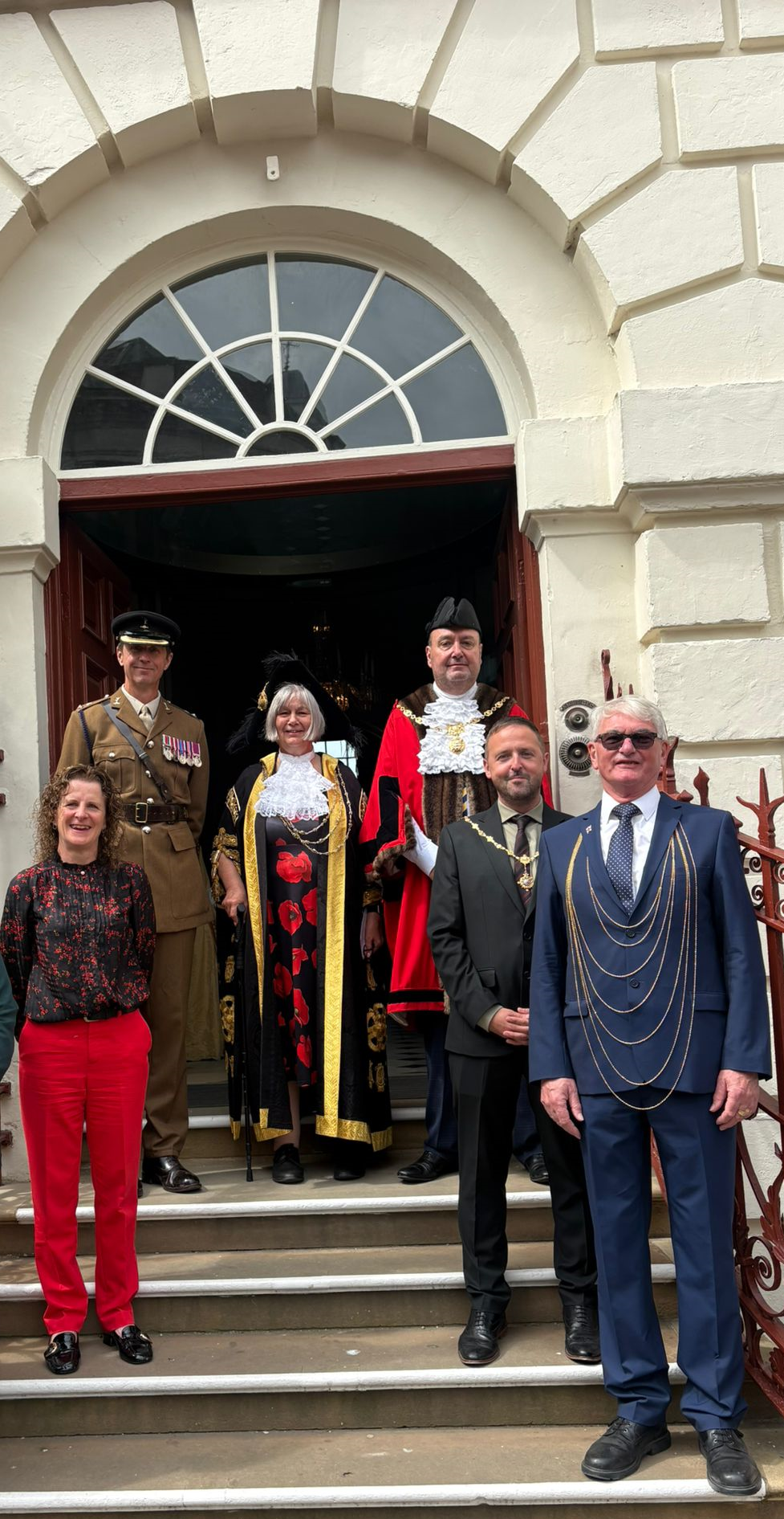 An image of a group of people including the Rt Hon Lord Mayor of York, Cllr Margaret Wells, Cllr Claire Douglas and members of the Armed Forces on the steps of the Mansion House
