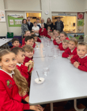 A group of happy looking children enjoying their breakfast at Burton Green Primary, with donors to the York Hungry Minds Appeal.