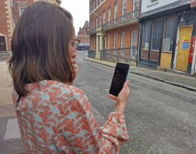 Woman looks in concern at her phone
