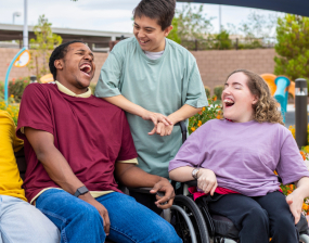 Two men and a woman share a joke