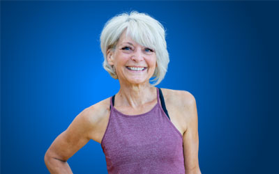 Health Trainers - Smiling slender older woman in running vest