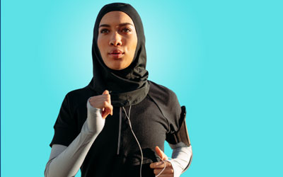 Health Trainers - Woman in sportswear, running with headphones and fitness arm band