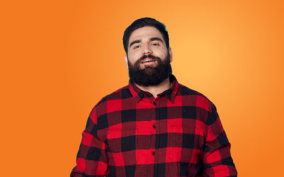 Health Trainers - Bearded man in checked shirt, smiling