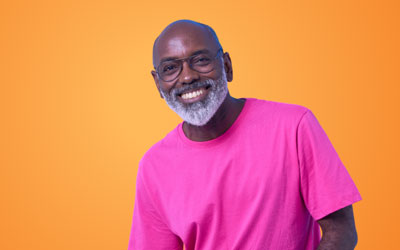 Health Trainers - Man with white beard, wearing pink t-shirt, smiling