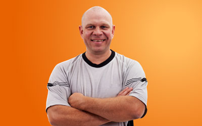 Health Trainers - smiling man with strong arms folded