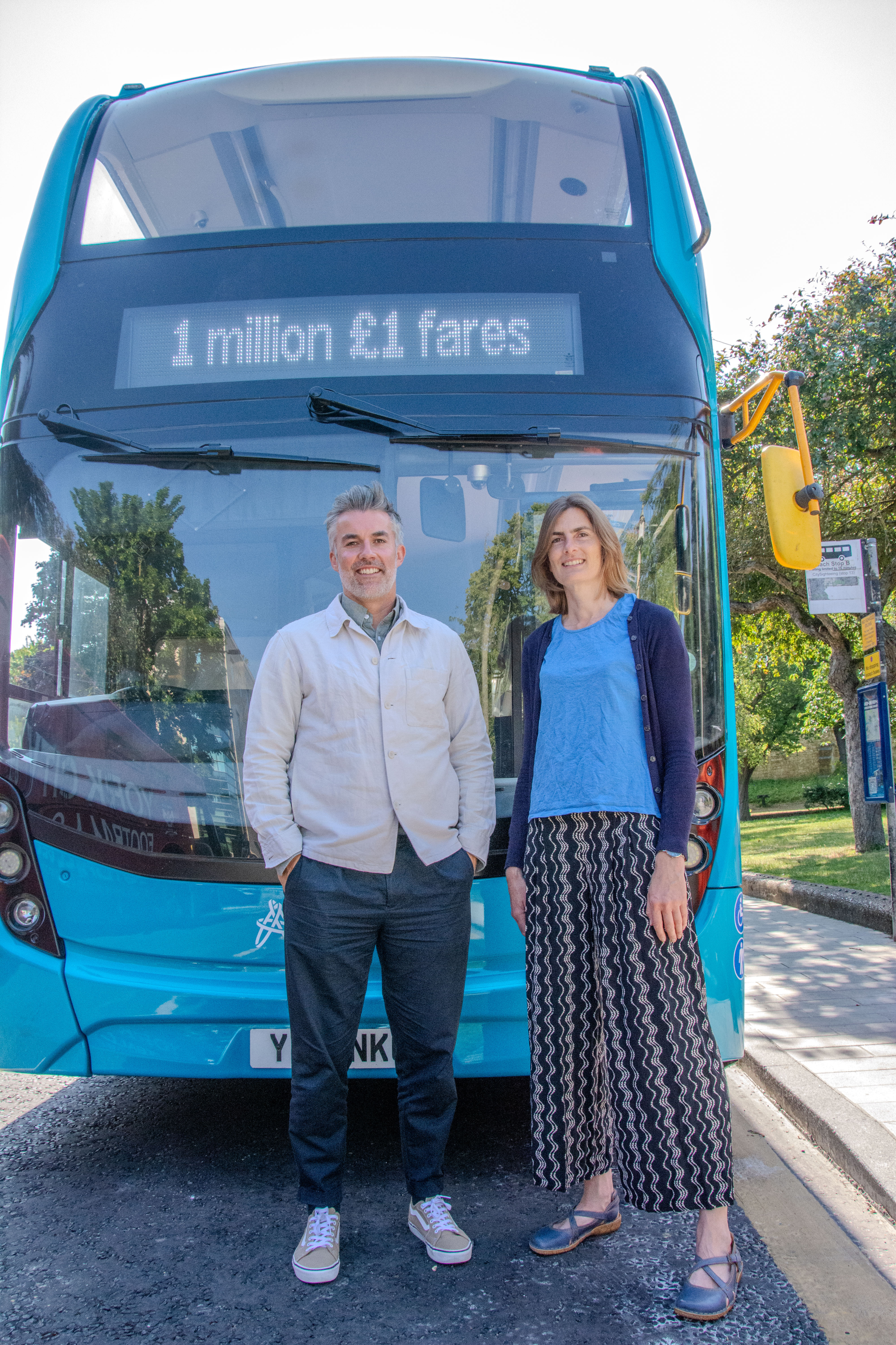 The Mayor of York and North Yorkshire stands with Councillor Kate Ravilious in front of a bus whose destination board reads 1 million £1 fares