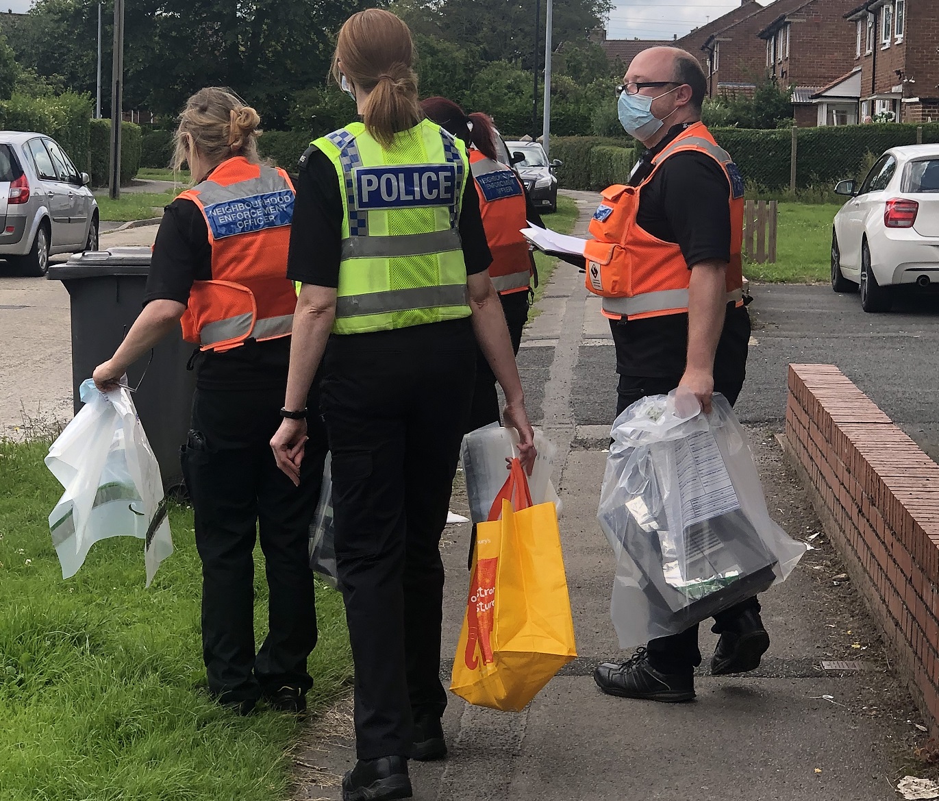 Officers remove seized equipment