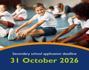 image of children sat on the floor doing stretches in PE