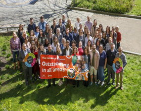 Photo of city of york council's children's social care team outside holding an Oftsed Oustatnding banner