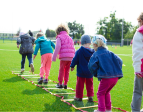 A stock image of a group of children playing outdoors