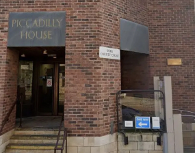 A brick and stone building with a sign saying 'County Court'