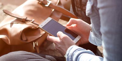 Hands holding a mobile device