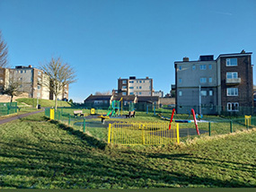 Council homes exterior view, with play area.