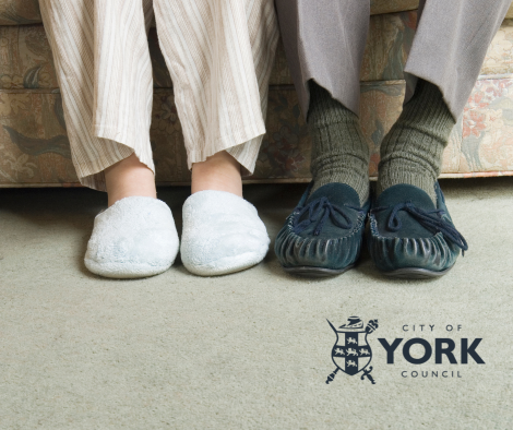 Two pairs of slippered feet