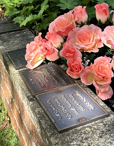 Bronze plaque memorial on raised flowerbeds