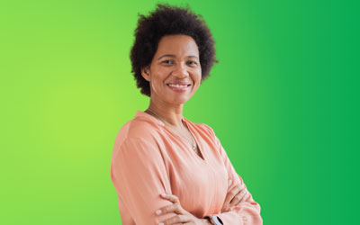 Woman with arms folded in front of a green background