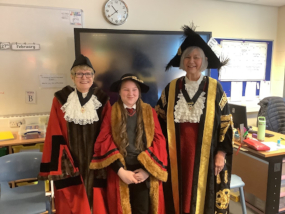 The Sheriff and Lord Mayor with a student dressing up in civic robes