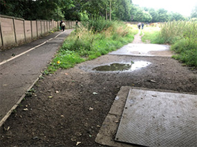 Manhole covers and underground services close to the existing riverside path