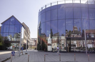 Older premises in York city centre reflected in the glass-fronted modern buildings