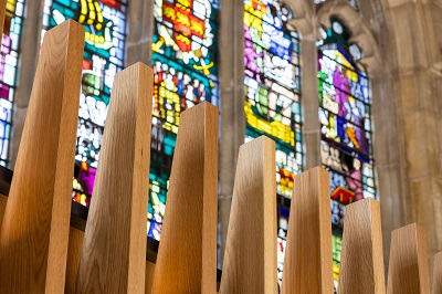 Oak screen fins and stained glass windows in the main hall of the Guildhall