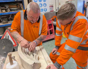 A photograph of two Stonemasons working
