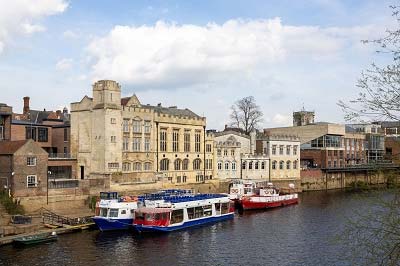 View of the guildhall from across the river Ouse.