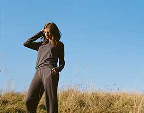 We Drifters clothing, woman in a field modelling pyjamas.