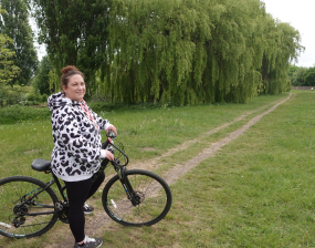 Cllr Steels-Walshaw on her bike cycling along the river in York