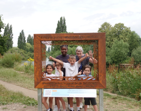 Image of young people and adult in a viewing frame on the Rivers Trail