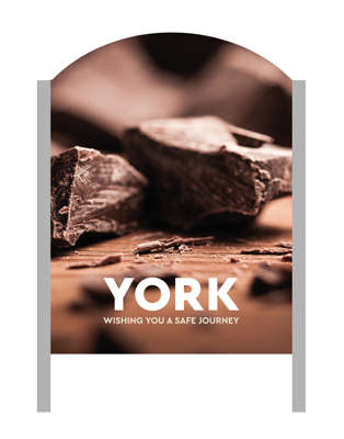 A 'Make It York' welcome sign with chocolate in the background.