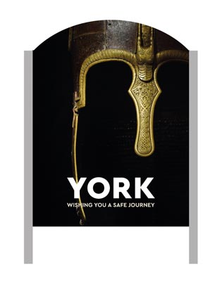 A 'Make It York' welcome sign with an Anglo Saxon helmet in the background.