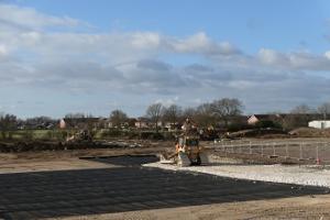 A bulldozer lays aggregate during the initial stages of construction work at York Community Stadium.