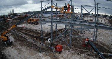 Cranes and workmen erect the stands as work continues at York Community Stadium.