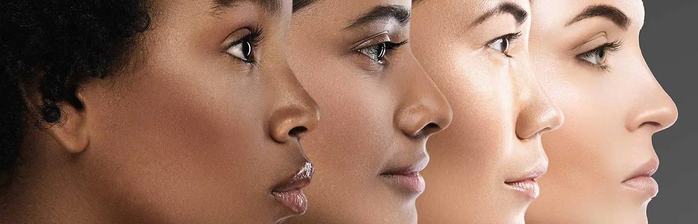 Faces of four woman from different ethnic backgrounds shown in a profile view.